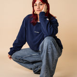 Woman wearing navy organic cotton crewneck by IT’S OKAY, relaxed fit.