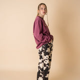 Side view of model wearing IT’S OKAY organic cotton crewneck bordeaux with relaxed fit.