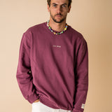 Model wearing IT’S OKAY organic cotton crewneck bordeaux burgundy, relaxed fit.