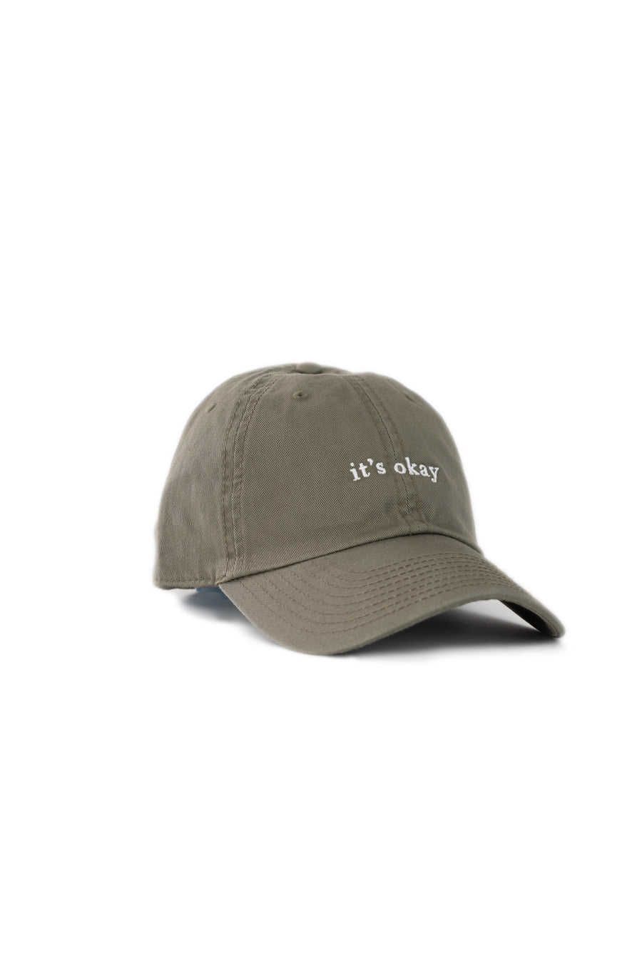 it's okay organic cap green| made with organic cotton, embroidered. This is a studio photography of the cap.