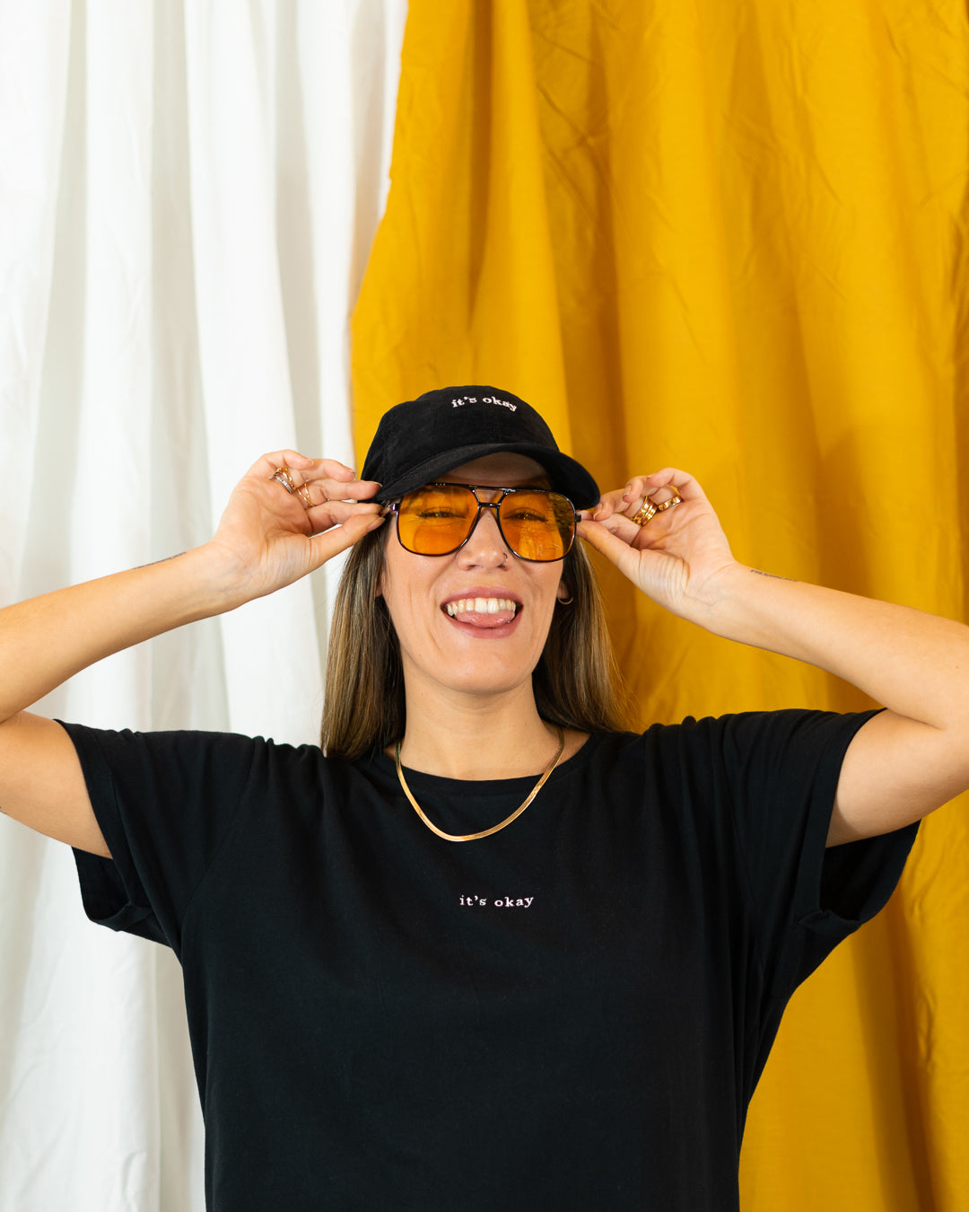 Night cap | cotton needlecord corduroy in black. Embroidered in Portugal. One size fits most | Wear it with pride. It's okay to be exactly who you are. Pt: Boné algodão de pala em bombazine de cor preta, tamanha ajustável.  Image: Girl with it's okay organic essential black t-shirt, sunglasses and night cap. 